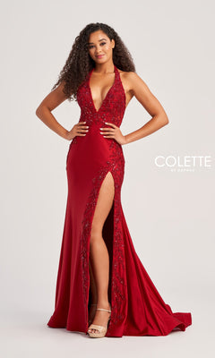 A woman poses confidently in the Lace-Bodice Colette Long Halter Prom Dress CL5206, a floor-length deep red gown with sparkly lace detailing and a high slit, styled with nude heels.