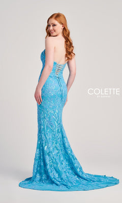 A woman in a strapless, corset-style light blue sequin floor-length gown with a train (Colette Strapless Sequin Long Prom Dress CL5238) stands turned to the side against a plain background.