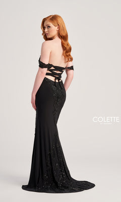 A woman with long red hair wears the Colette Off-Shoulder Long Formal Prom Dress CL5276, a black, floor-length gown with beaded lace applique, sequin embellishments, an off-shoulder neckline, and a lace-up back against a plain background.