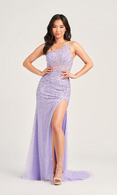 Woman wearing the Beaded Colette One-Shoulder Long Prom Dress CL5292, featuring a sleeveless design and high slit, poses with hands on hips against a plain light background.