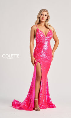 A woman models the Colette CL8070 long prom dress—fitted, bright pink, with sequins, spaghetti straps, and a thigh-high slit—against a plain white background.