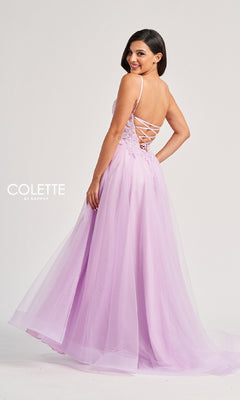 A woman stands smiling over her shoulder in the Colette CL8100 long prom dress, featuring a light purple hue, lace-up back, delicate lace embroidery, and a flowing tulle skirt.