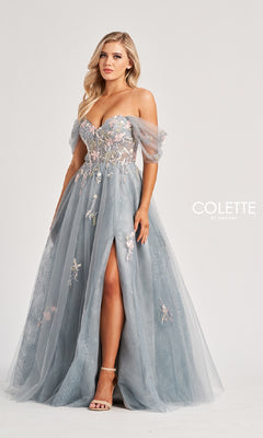 A woman wears the Colette CL8150, a light blue off-the-shoulder prom gown with floral embroidery, sheer bodice, tulle sleeves, embroidered sweetheart neckline, and thigh-high slit. The background is plain white with "Colette by Daphne" text.