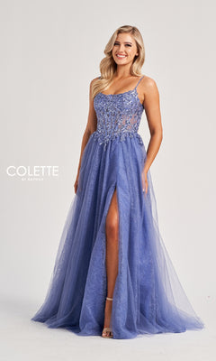 A woman wears the Colette CL8240 long prom dress, a sleeveless lavender gown with floral embellishments, an embroidered bodice, high slit, and a flowing tulle skirt.