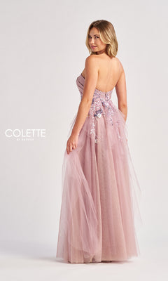 A woman models the Colette CL8400 Long Prom Dress—a light pink, strapless, floor-length gown with floral sequin details and a flowing tulle A-line skirt—posing slightly turned from the camera.