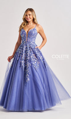 A woman stands against a plain background wearing the Colette CL8420, a sleeveless, floor-length lavender prom ball gown featuring glitter details and a low V-neckline.