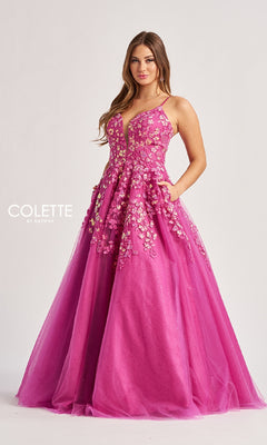 A woman poses against a light background in the Colette CL8420 Low V-Neck Glitter Prom Ball Gown, a floor-length designer dress with a fitted bodice and thin straps, exuding elegance.