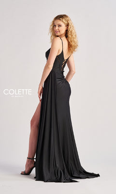 Woman in the Sheer-Cut-Out Long Prom Dress: Colette CL8480, a black gown featuring a thigh-high slit and open back, standing in profile and looking over her shoulder against a plain background.