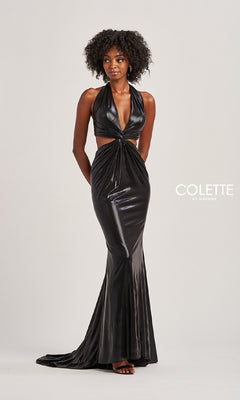 A woman wears the Colette CL8505, a shiny black halter prom dress with side cutouts and a front knot detail. The fitted silhouette and slight train give this long gown an elegant, modern look against a plain background.