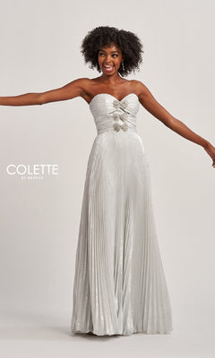 Woman modeling the Colette CL8520, a strapless long pleated prom dress with rhinestone bows at the bust, standing with arms outstretched against a plain background.
