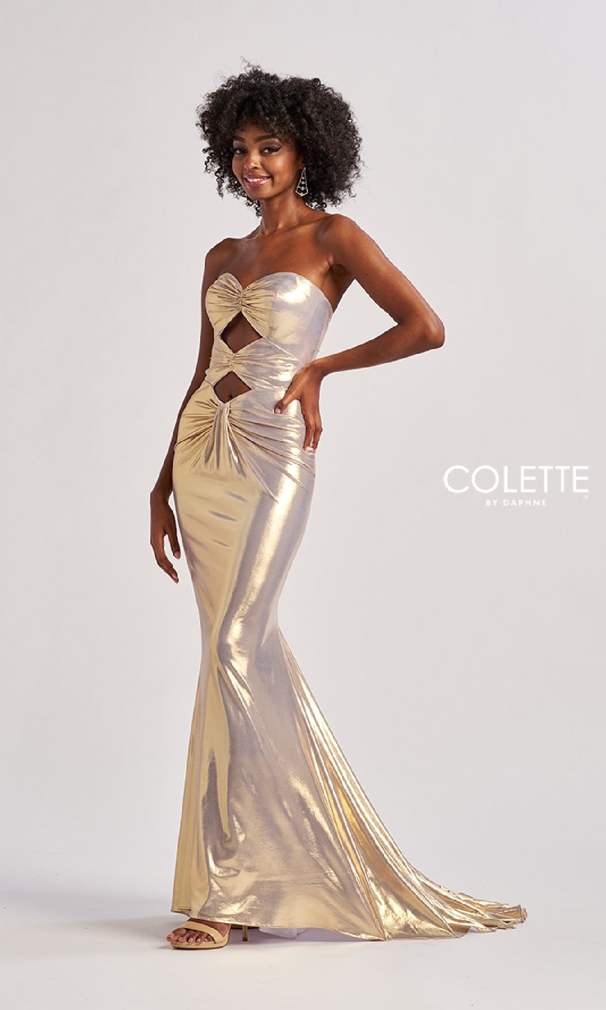 A woman models the Long Prom Dress: Colette CL8545, a strapless metallic gown with front cutouts, against a plain background. The text 