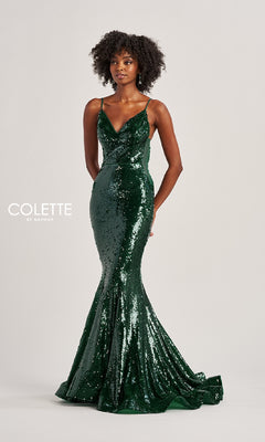 A woman wears a fitted, floor-length green Long Prom Dress: Colette CL8615 with thin straps, standing against a plain light background.