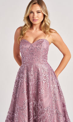 A woman stands against a plain background wearing the Colette CL8625, a floor-length lavender prom dress with strapless design and intricate sequin and bead embellishments.
