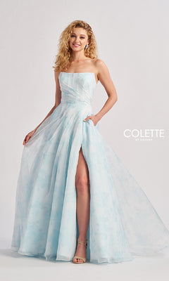 A woman models the Long Prom Dress: Colette CL8635, a strapless light blue floral pastel gown with a thigh-high slit, standing against a plain background with "Colette by Daphne" text on the right.