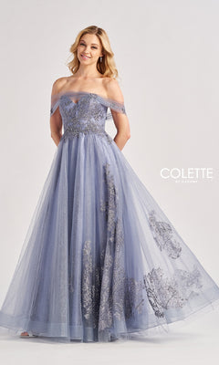 A woman in the Colette by Daphne Long Prom Dress CL8640, featuring a floor-length, sweetheart neckline in lavender with silver floral embroidery, stands against a plain background. The "Colette by Daphne" logo is visible.