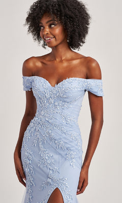 A woman models the Off-the-Shoulder Long Prom Dress: Colette CL8645 in light blue, featuring floral embroidery, a mermaid silhouette, and a front slit—a stunning choice for any formal occasion.