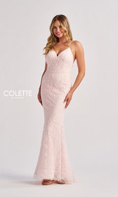 A woman poses elegantly against a plain white background, wearing the Colette CL8655 long prom dress—a light pink, floor-length gown with a fitted lace design, delicate spaghetti straps, and a subtle v-neckline.