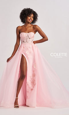 Woman wearing the Colette CL8660 long prom dress with a strapless sheer lace bodice and embroidered floral A-line skirt, standing against a plain white background.