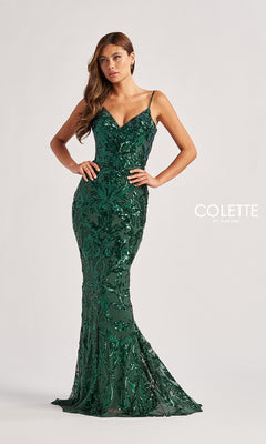 A woman poses in the Colette CL8685, a fitted, floor-length emerald green sequin prom dress with thin straps, mermaid silhouette, and elegant leaf-pattern design.