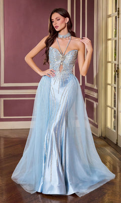 A woman stands in an ornate room, wearing the Ladivine CM391 long prom dress in dusty blue, featuring sequin embellishments, a sheer overlay, and a matching choker.