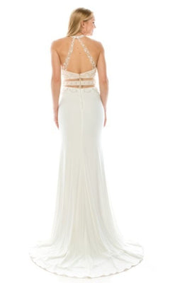 A woman in the Chicas CR7001 Faux Two-Piece Long Prom Dress, featuring a white floor-length design with a halter neckline, open back, lace straps, and sheer panel details.