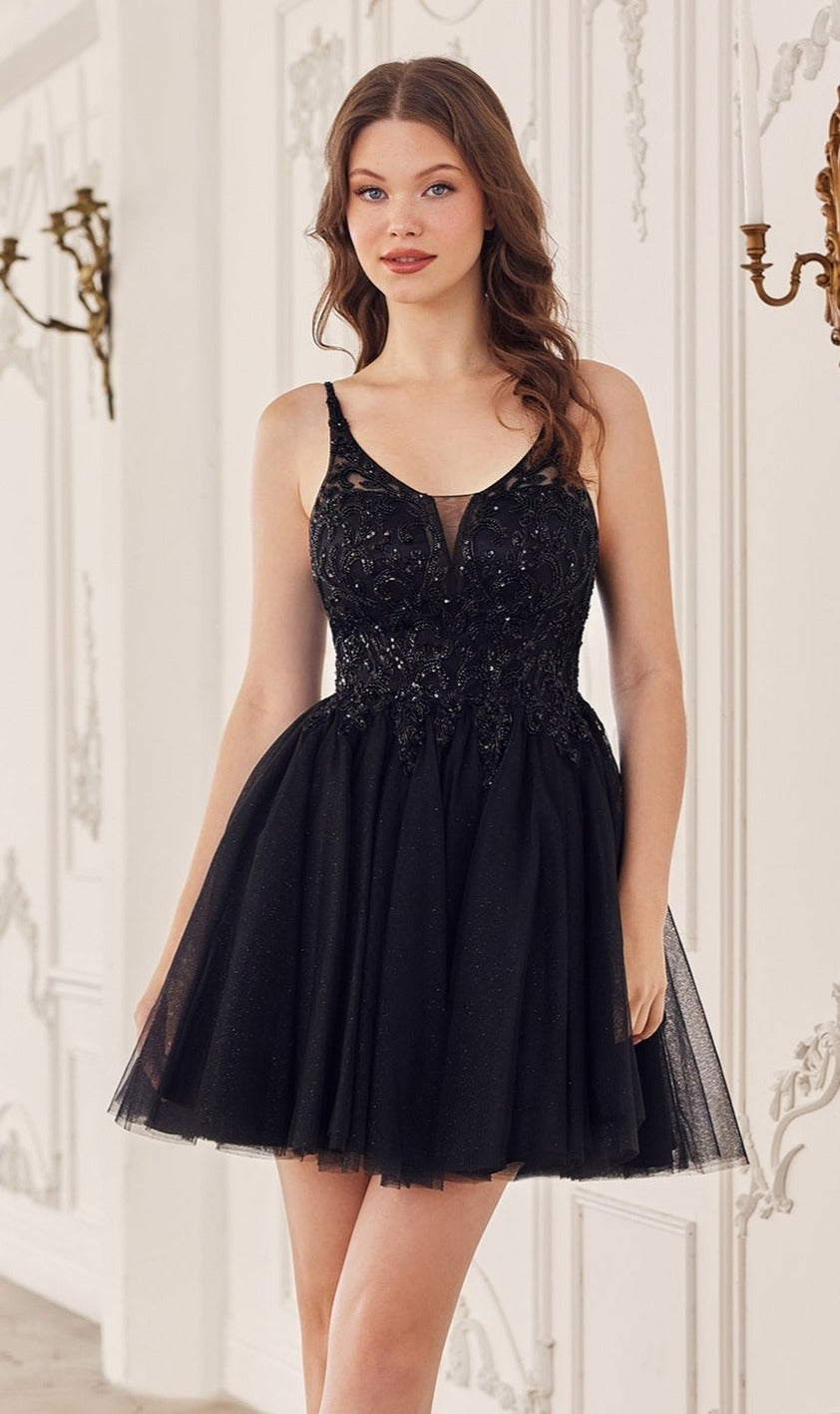 A woman stands indoors wearing the Lace-Up Short A-Line Homecoming Dress CY022, featuring a fitted beaded bodice and flared tulle skirt. She faces forward with her arms relaxed at her sides.