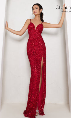 A woman poses in the Long Prom Dress 30161 by Chandalier—a red sequin formal gown featuring spaghetti straps and a thigh-high side slit—against a white background.