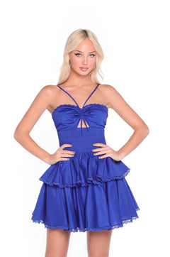 Woman wearing the Navy Short Casual Dress: Corinne—featuring a smocked bodice, sleeveless layered mini style, thin straps, and a chest cutout—stands against a white background.