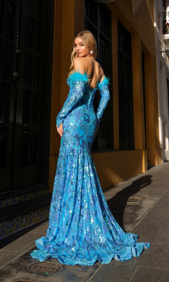A woman stands on a sidewalk wearing the Strapless Sequin-Print Prom Dress with Gloves D1269, a fitted blue evening gown featuring a flowing train and elegant feathered details on the sleeves.