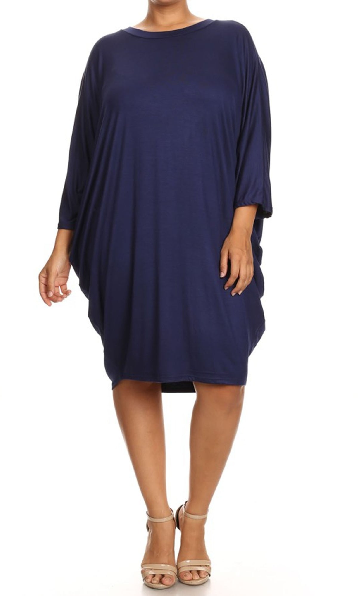 A person wearing the Short Casual Plus Size Dress with Dolman Sleeves—loose-fitting, navy blue, knee-length, with three-quarter sleeves—paired with beige sandals, stands against a plain white background.