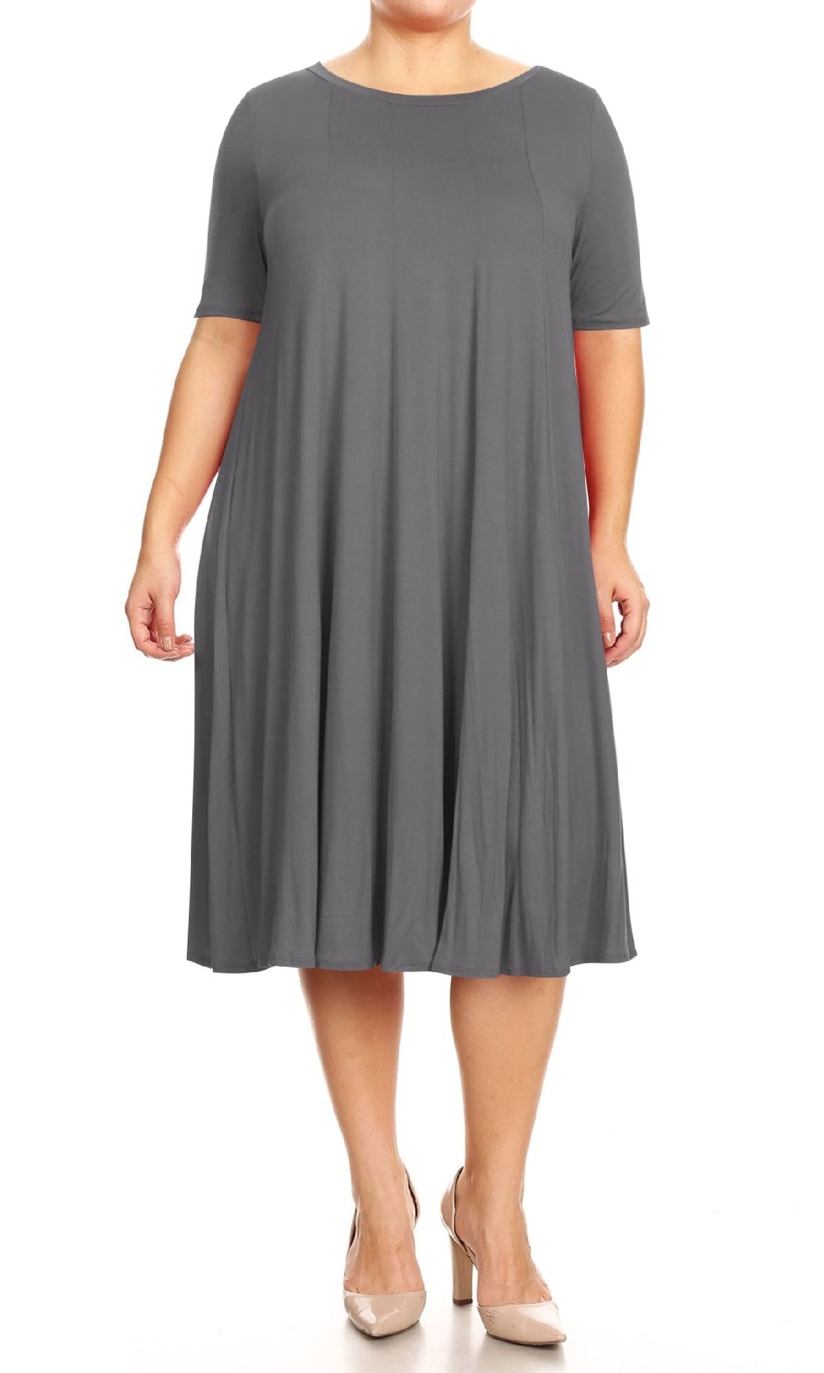 A person models the Plus-Size Jersey Knit Oversized A-Line Casual Dress—a loose, short-sleeve, knee-length gray outfit—paired with neutral heels against a white background.