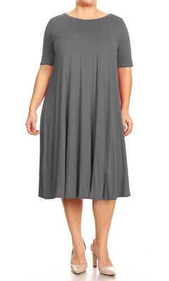 A person models the Plus-Size Jersey Knit Oversized A-Line Casual Dress—a loose, short-sleeve, knee-length gray outfit—paired with neutral heels against a white background.