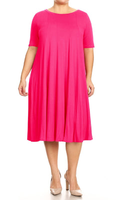 A person wears the Plus-Size Jersey Knit Oversized A-Line Casual Dress in bright pink with short sleeves, paired with beige heels, standing against a white background.