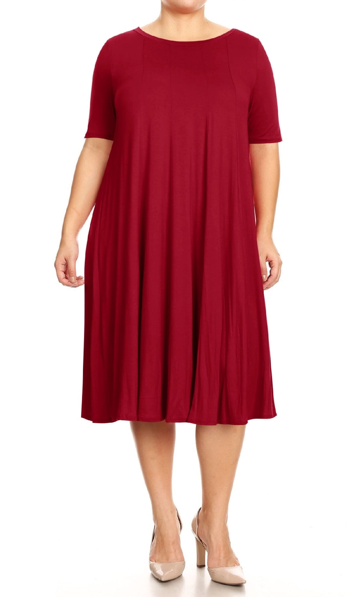 A person in a red Plus-Size Jersey Knit Oversized A-Line Casual Dress with short sleeves and beige heels stands against a white background.