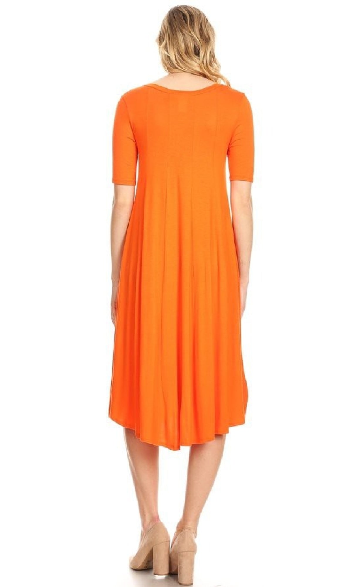 A woman faces away, wearing the Short Sleeve Casual Oversized Jersey Knit Dress in bright orange with beige heeled shoes.