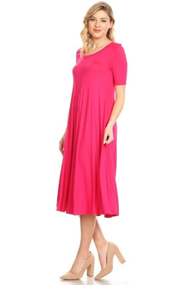 A woman stands against a white background wearing the Short Sleeve Casual Oversized Jersey Knit Dress in bright pink with nude heels.