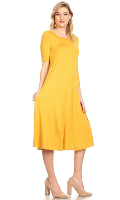 A woman wearing the Short Sleeve Casual Oversized Jersey Knit Dress in yellow with beige heels stands against a plain white background.