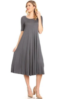 A woman poses against a white background wearing the Short Sleeve Casual Oversized Jersey Knit Dress in grey with beige heels.