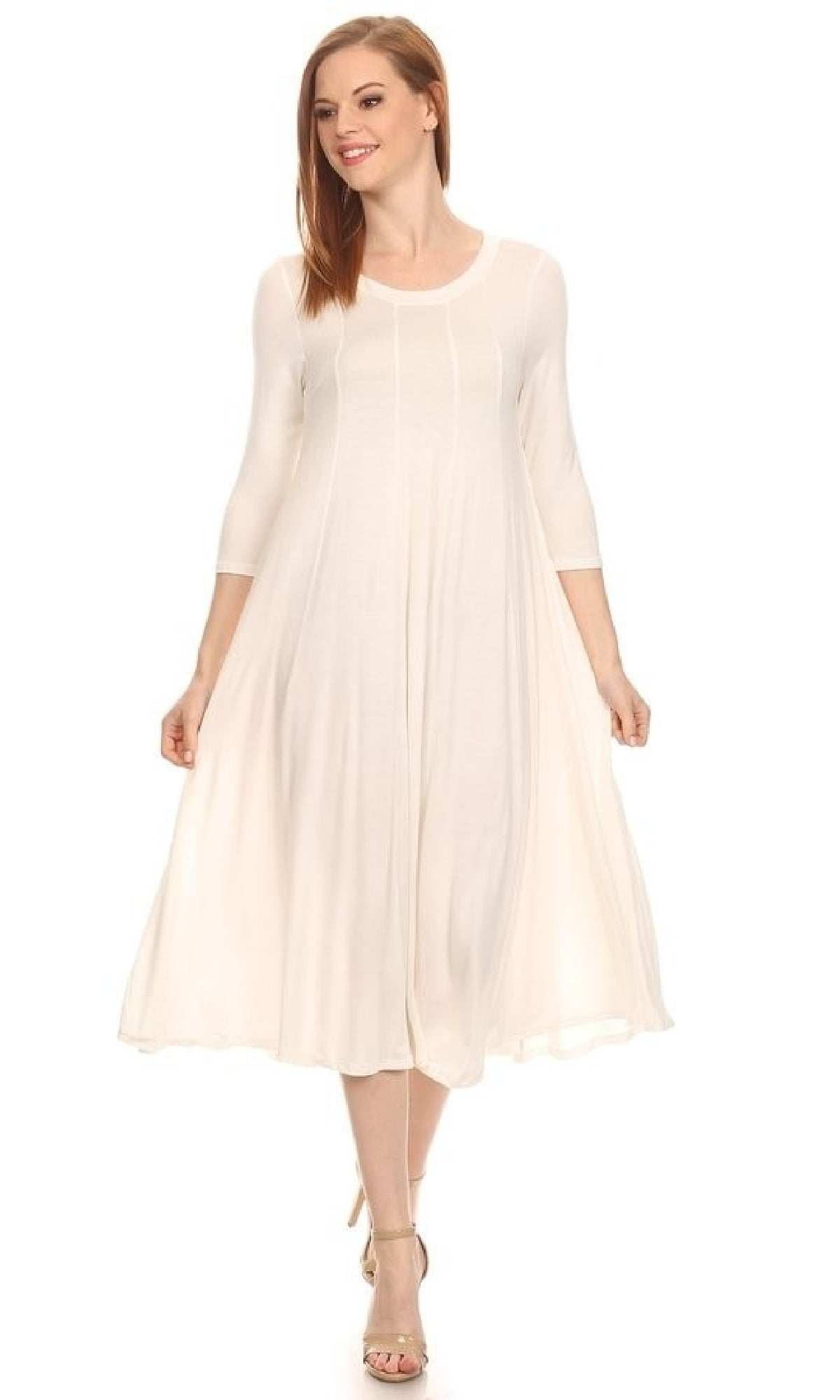 A woman wearing the Knee-Length Casual Party Dress stands against a plain background, pairing it with long sleeves and beige high-heeled sandals.