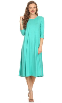 A woman in a teal Knee-Length Casual Party Dress with three-quarter sleeves and silver open-toe heels stands against a white background.