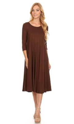 A woman models the Knee-Length Casual Party Dress with three-quarter sleeves and beige heels, standing against a plain white background.