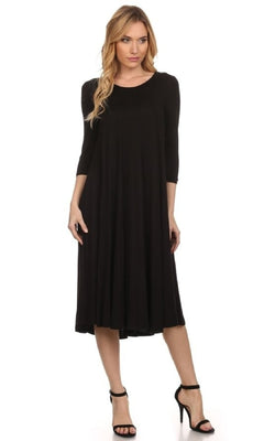 A woman stands against a white background wearing the Knee-Length Casual Party Dress in black with long sleeves, paired with black high-heeled sandals.