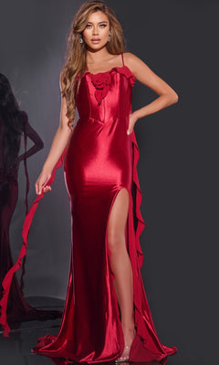 A woman models the Jovani D5078, a long, shiny red satin prom dress with a backless design, thigh-high slit, 3D flower neckline, and ruffled straps, standing against a dark background.