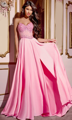 A woman wearing the Jovani D6021 Pink Long Prom Dress with a beaded corset bodice and flowing A-line skirt stands indoors against ornate, gold-trimmed walls.