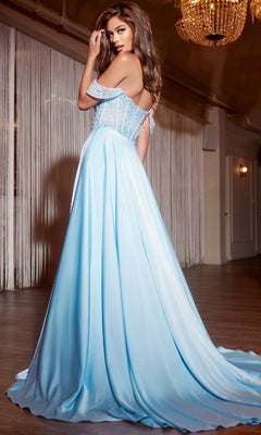 A woman in the Jovani D6022 long blue prom dress, featuring an off-the-shoulder neckline and beaded corset bodice, stands indoors looking over her shoulder at the camera.