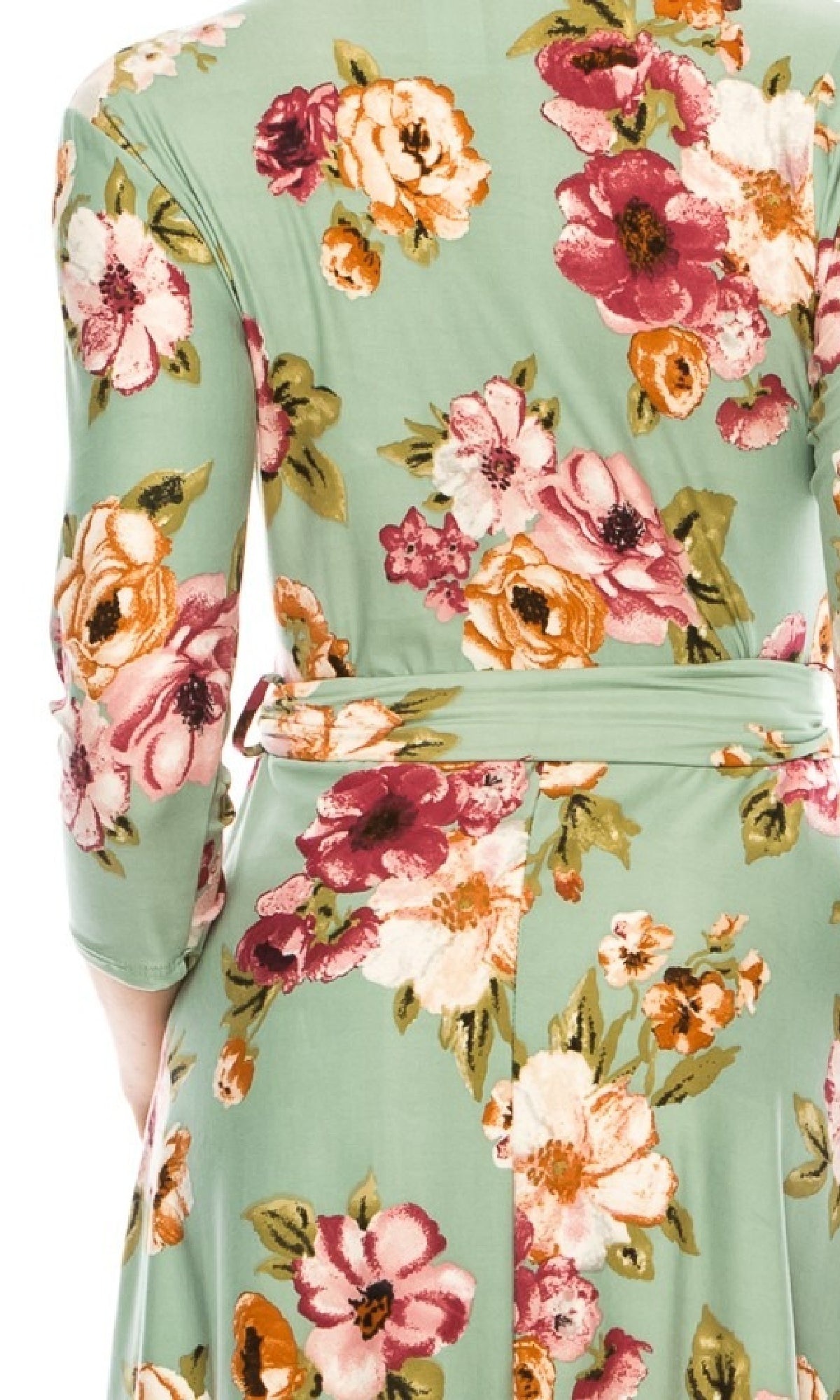 A close-up of a person wearing the Sage Green Floral Print Faux-Wrap Casual Dress featuring a belted waist and colorful pink, white, orange, and green patterns.