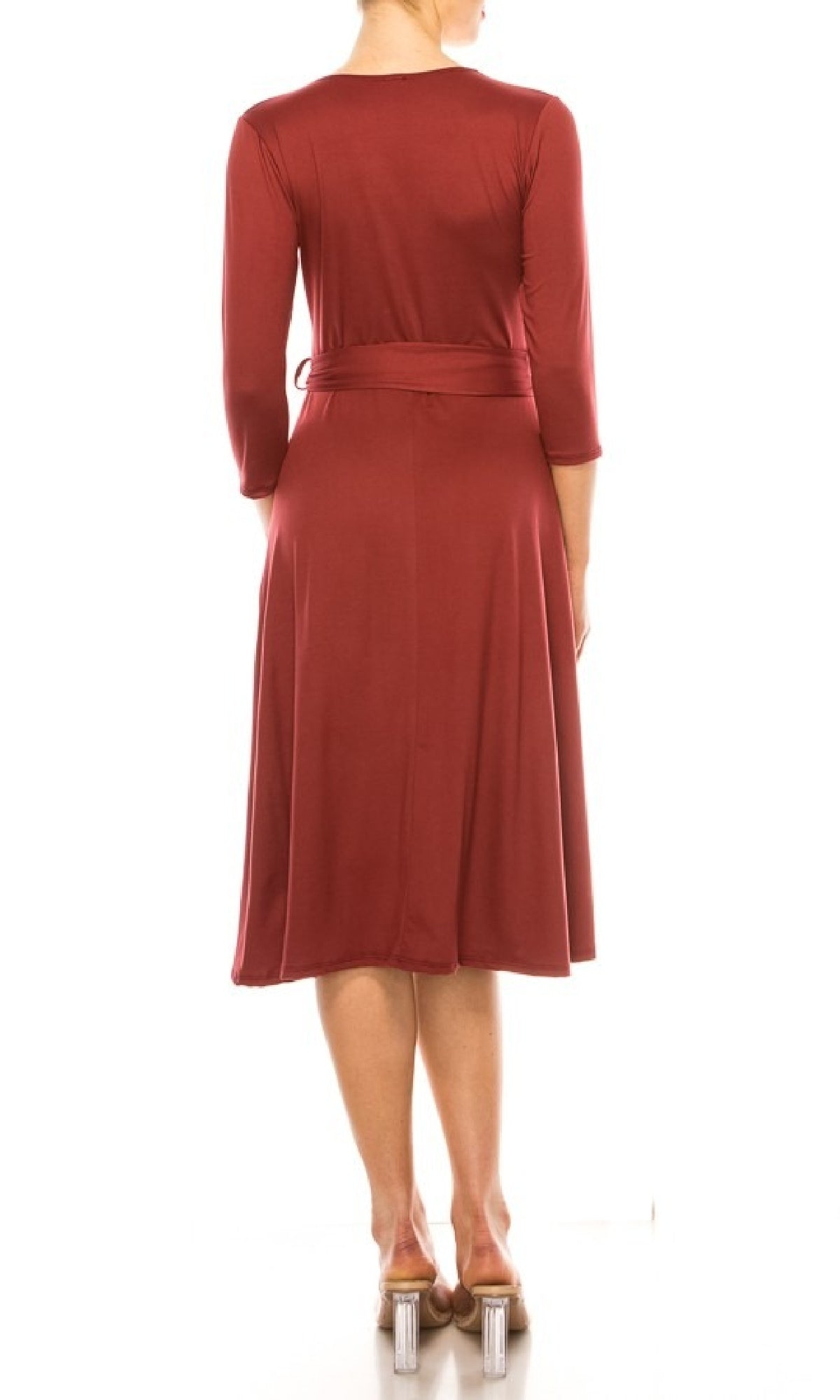 A woman stands facing away, wearing the Faux-Wrap Casual Short Dress with Sleeves in maroon, knee-length with a belt, paired with clear-heeled shoes.