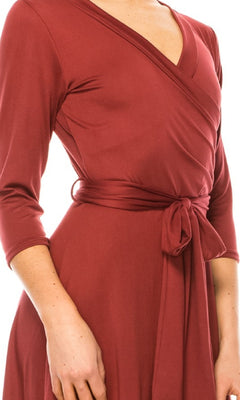 A person wearing the Faux-Wrap Casual Short Dress with Sleeves, featuring a knee-length cut, three-quarter sleeves, v-neckline, and a tied waist belt, shown from shoulders to mid-thigh.