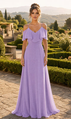 A woman wearing the Long Formal Dress: Chicas DM4004 in lilac stands outdoors on a stone path surrounded by greenery, shrubs, and distant hills in the background.