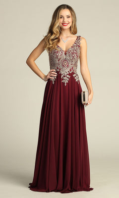 A woman stands smiling against a plain background, holding a small clutch purse while wearing the Long Formal Dress: Chicas DM4006 in plum—a sleeveless gown featuring an embroidered bodice and a flowing chiffon A-line skirt.